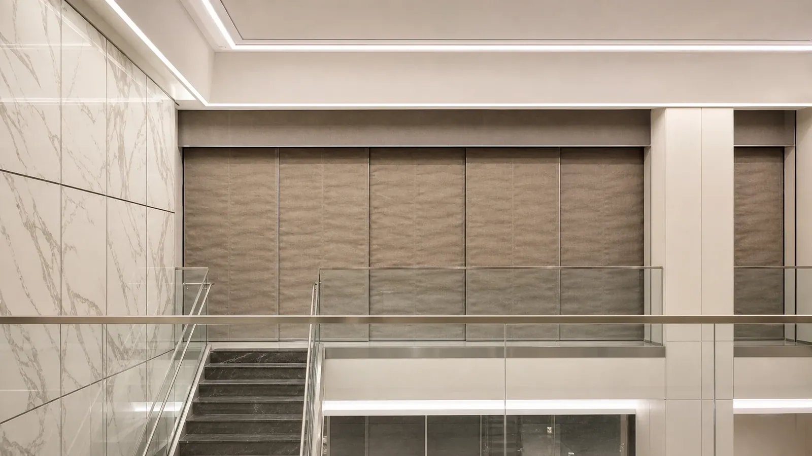Deployed smoke curtain panels above a lobby stair in a commercial building